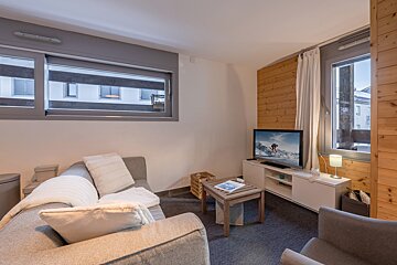 A living room with a couch and a flat screen tv