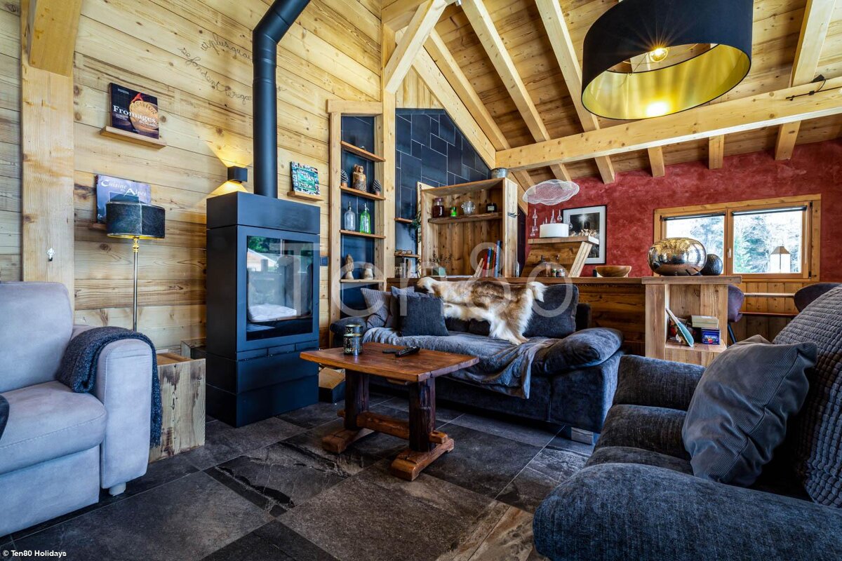 A living room with a couch a chair and a fireplace