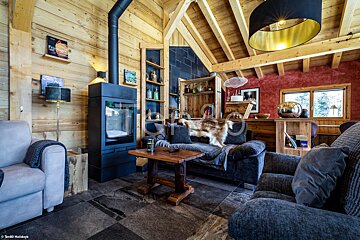 A living room with a couch a chair and a fireplace