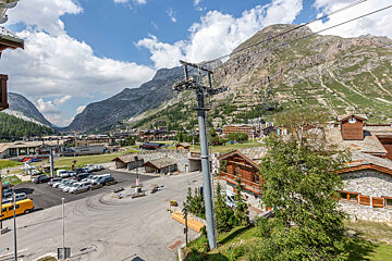 A view of a ski resort with mountains in the background