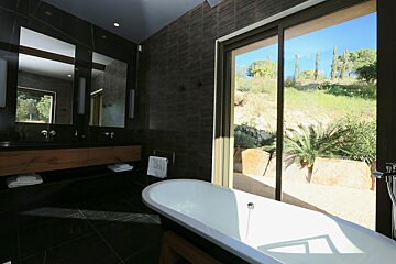 A bathroom with a sliding glass door and a bathtub