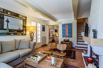 A living room with a couch and chairs and a fireplace