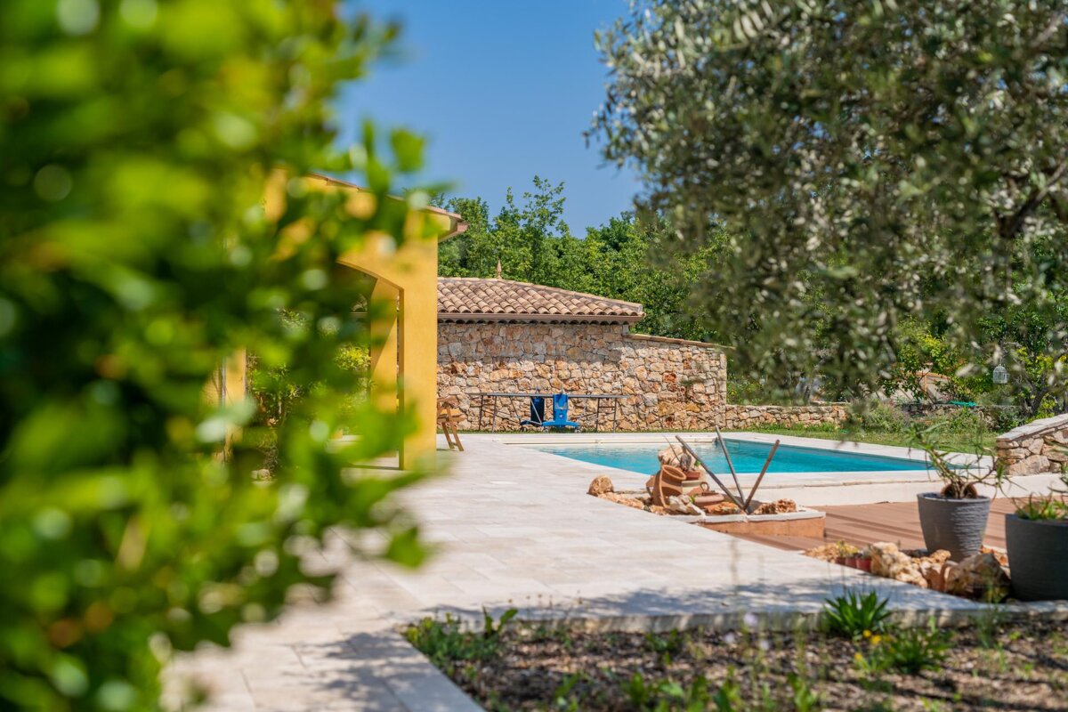 A swimming pool with a yellow building in the background