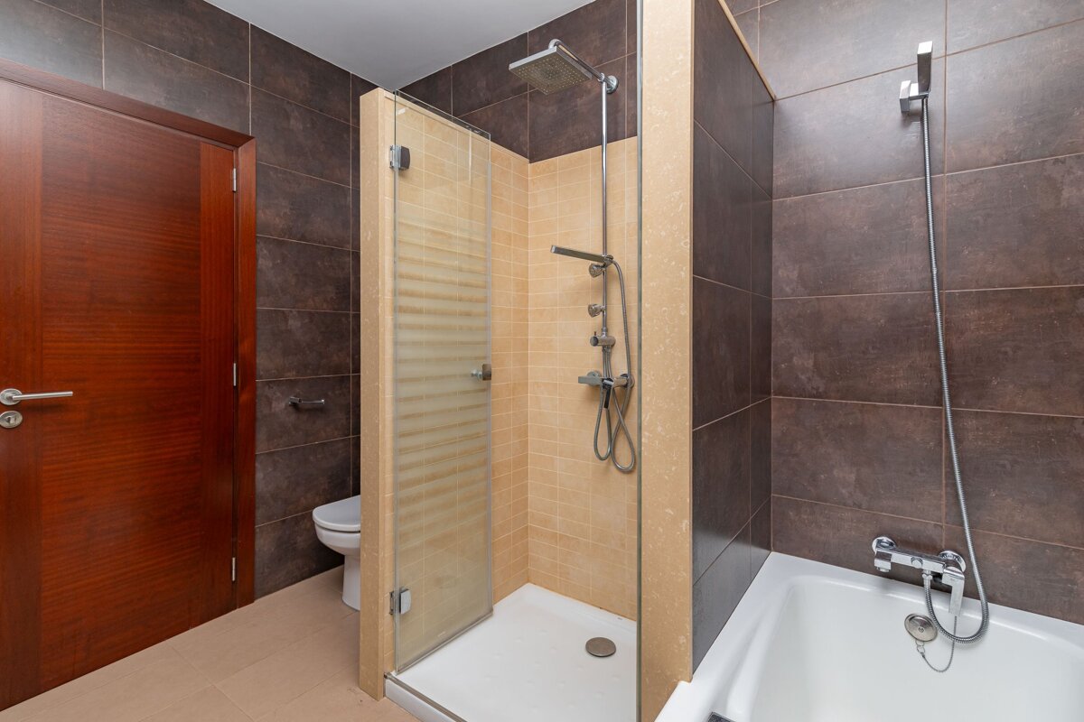 A bathroom with a walk in shower and a bathtub