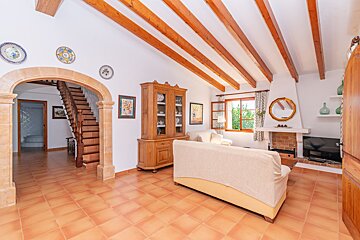 A living room with a fireplace and a staircase