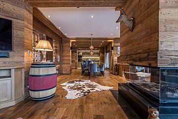A living room with a barrel and a lamp