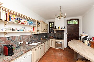 A kitchen with a nespresso coffee maker on the counter