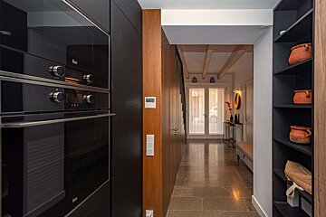 A kitchen with a black oven that says ' teka ' on it