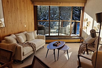 A living room with a couch and two coffee tables