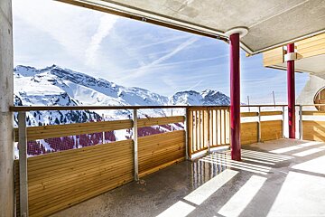 A balcony with a view of snow covered mountains