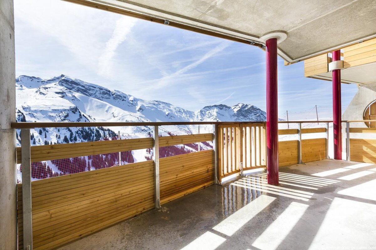 A balcony with a view of snow covered mountains