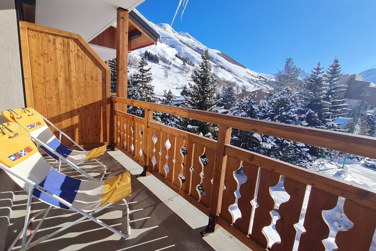 Two chairs on a balcony with the word ski on them
