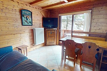 A wooden room with a tv and a sign that says
