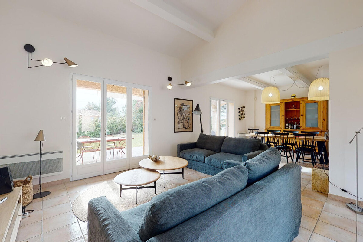 A living room with a blue couch and a table