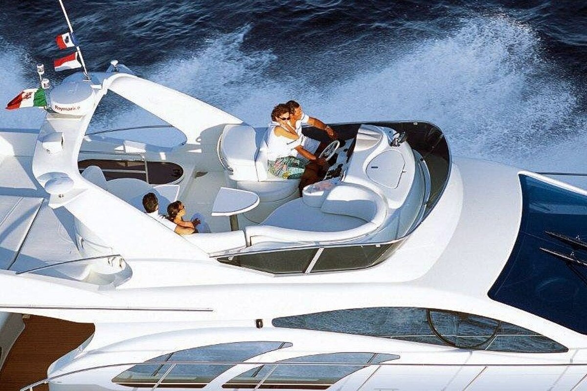 A couple sits on the deck of a white yacht