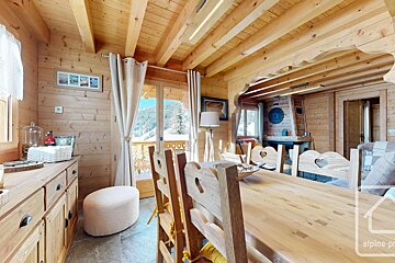 A wooden dining room with a sign that says alpine-prop
