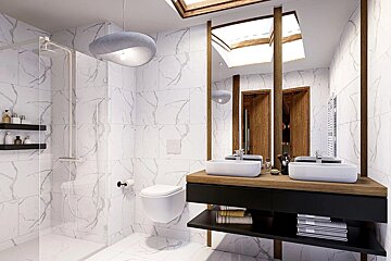 Modern bathroom with white marble tiles, a walk-in shower, floating toilet, and a double-sink wooden vanity with skylights.