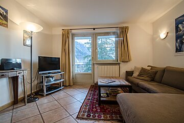 A living room with a couch and a flat screen tv