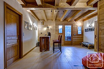 A wooden hallway with a sign that says alpine property
