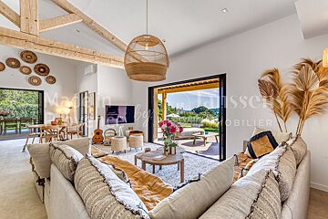 A living room with a sliding glass door and a sign that says mobilier