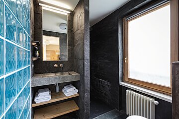 A bathroom with a sink and a window
