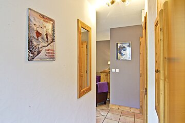 A hallway with a poster on the wall that says