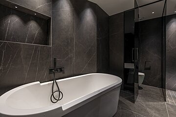 A bathroom with a bathtub and a toilet