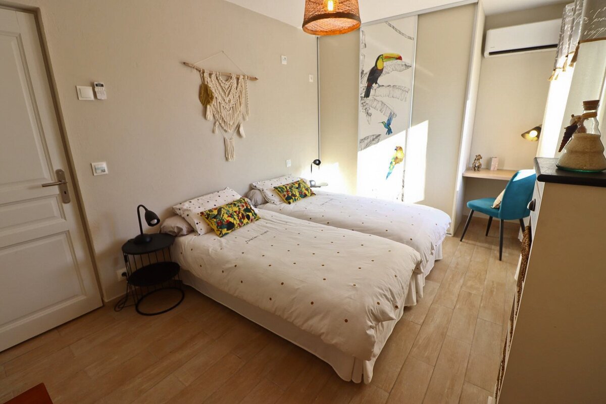 A bedroom with two twin beds and a desk