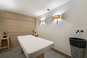 A bedroom with a large bed and a bathtub