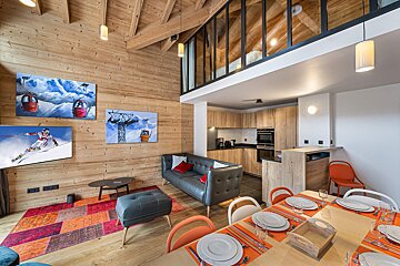 A living room with a couch and a dining table