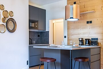 A kitchen with a microwave and a coffee maker