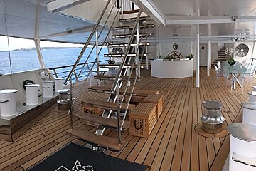 A wooden deck with stairs and a sign that says ricco ferrari