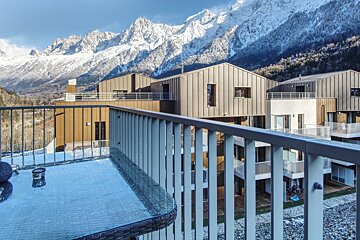 A balcony with a view of snow covered mountains