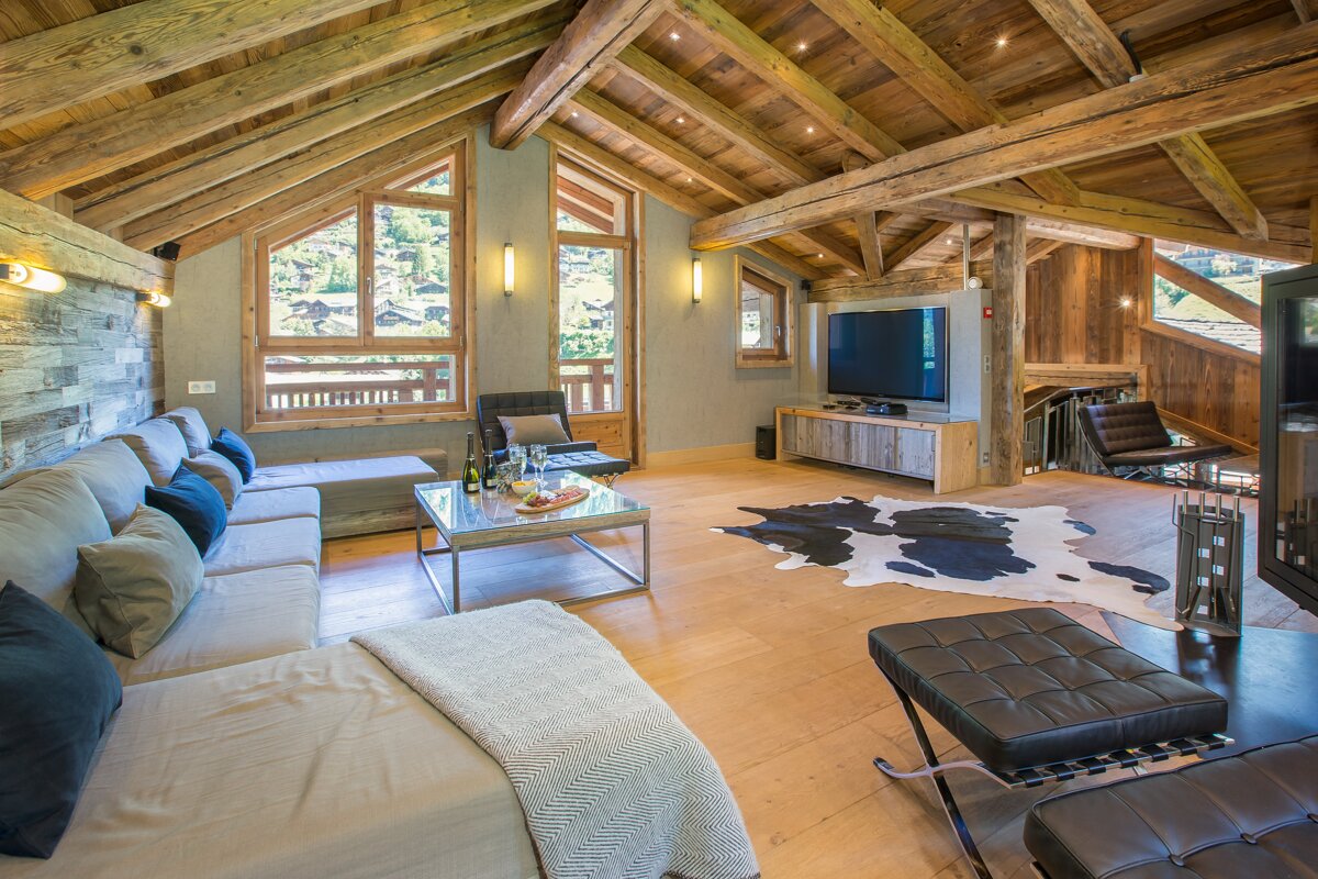 A living room with a cowhide rug on the floor