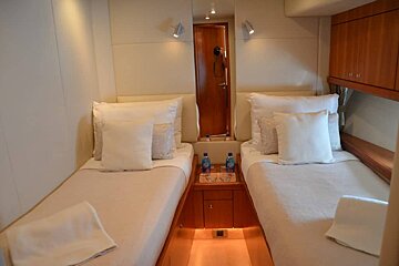 A bedroom with two twin beds and two bottles of aquafina water on the nightstand