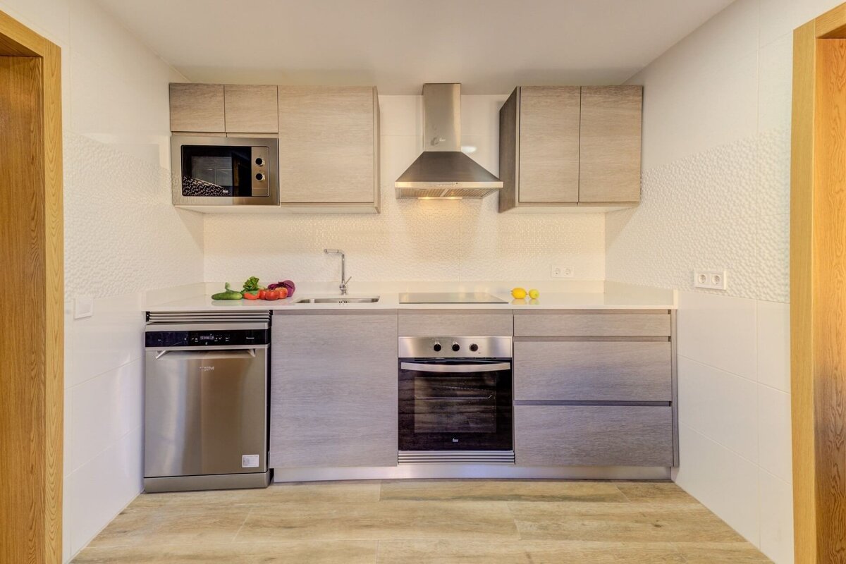A kitchen with stainless steel appliances including a dishwasher