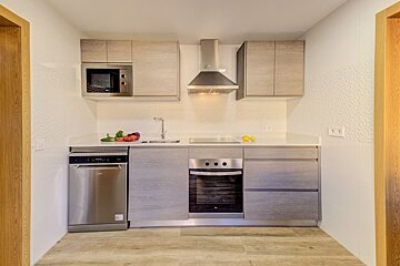 A kitchen with stainless steel appliances including a dishwasher