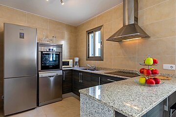 A kitchen with stainless steel appliances and a samsung refrigerator