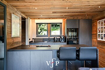 A kitchen with a poster on the wall that says verona
