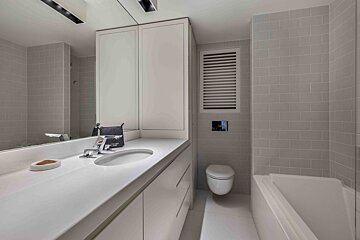A bathroom with a toilet a sink and a mirror