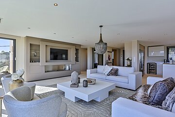 A living room with a white couch and a white coffee table