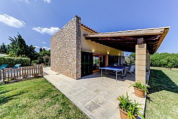 A house with a ping pong table in front of it