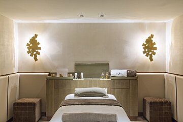 A room with a bed and two ottomans that says cb on it