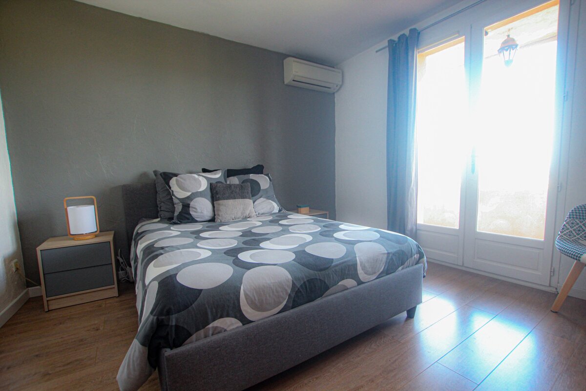 A bed with a polka dot comforter and pillows in a bedroom