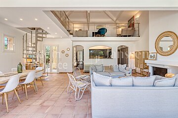 A living room with a couch and chairs and a sign that says immobilier