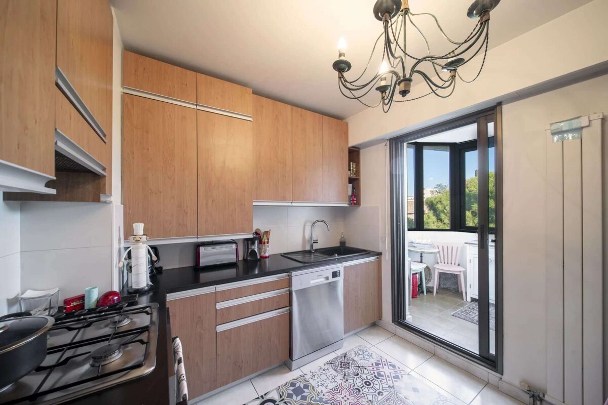 A kitchen with wooden cabinets and stainless steel appliances