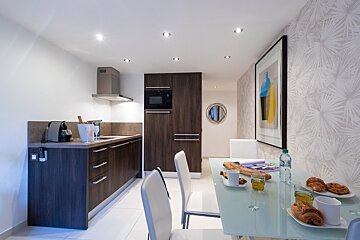 A kitchen with a bottle of water on the table