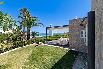 A view of the ocean from the backyard of a house