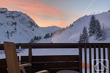 A view of a snowy mountain from a balcony