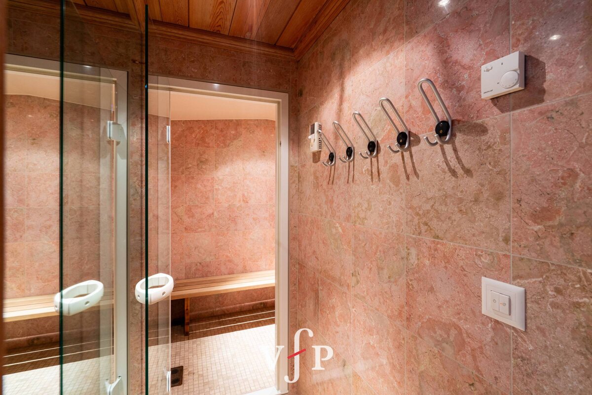 A bathroom with pink tiles and a sign that says fp